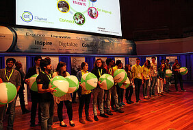 Crew and coaches on stage carrying 'core values'